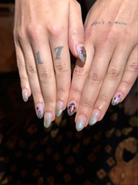 Halsey's tattooed hands wearing a shimmery manicure